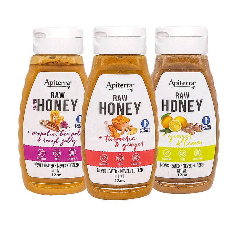 Three jars of  twelve ounces raw honey with superfoods